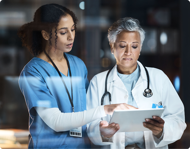 a nurse and a doctor examine records on a tablet