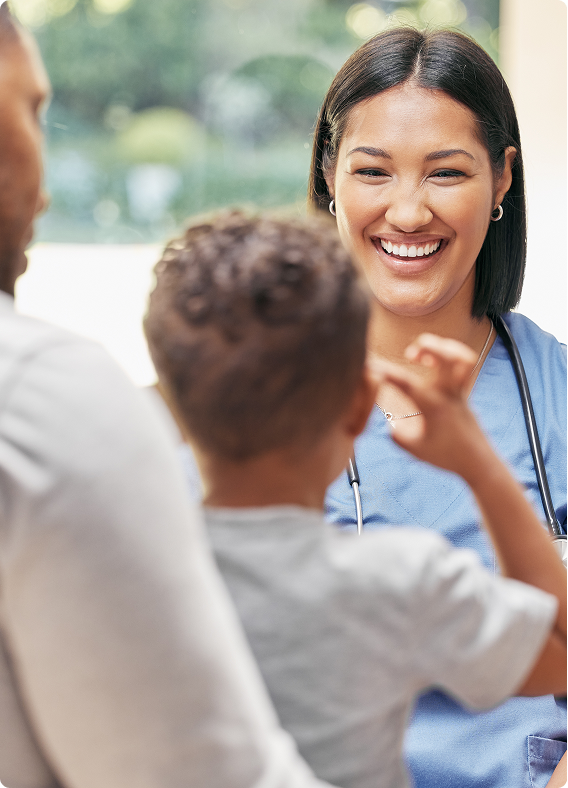 a pediatric doctor or nurse smiling at a child patient